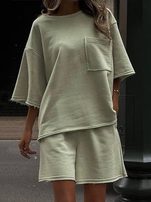 Sage raw-edge pocket tee and Bermuda shorts set with frayed hems.