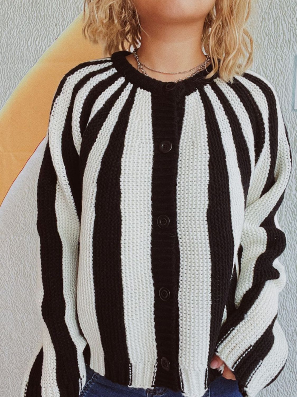 Bold stripe knit cardigan with button-up front and crew neck.