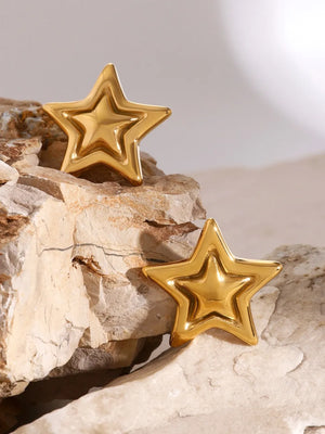 Gold sculpted starburst stud earrings with layered star design