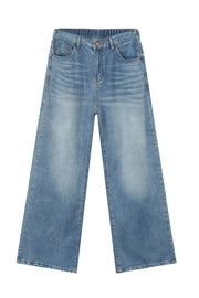 Oversized baggy denim trousers in medium wash with elastic waistband and wide legs.