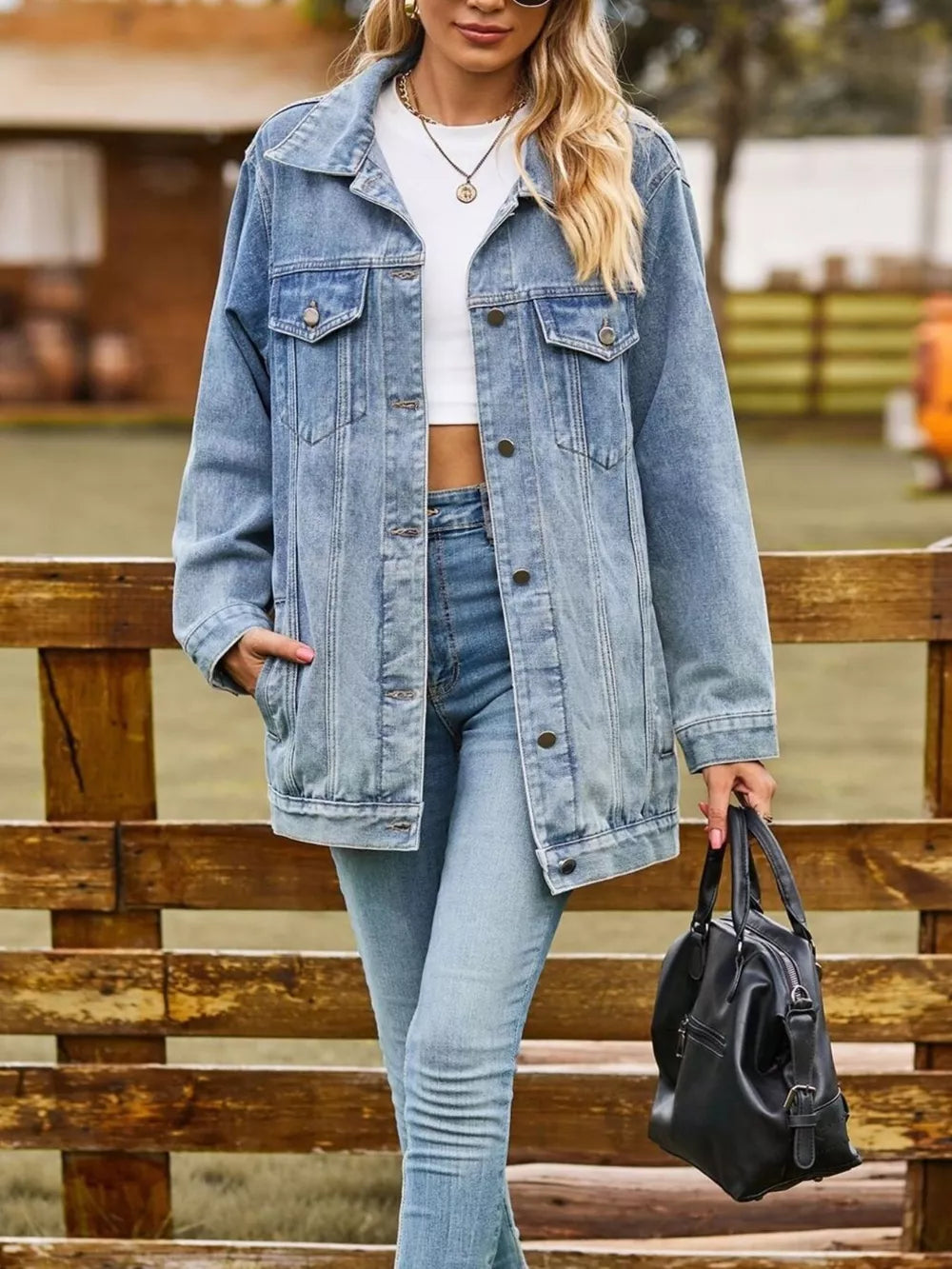 Relaxed fit denim trucker jacket in medium wash with button-down front and chest pockets.