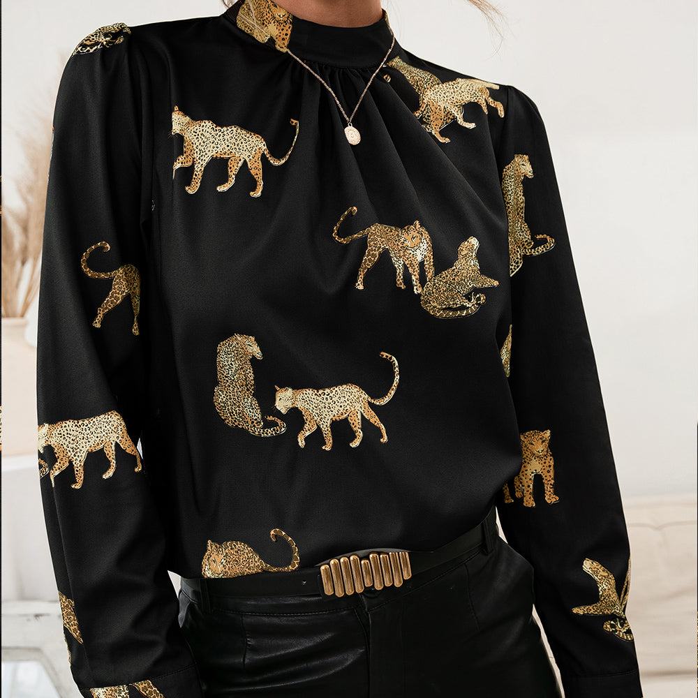 Black leopard print blouse with keyhole neck and long sleeves.