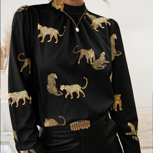 Black leopard print blouse with keyhole neck and long sleeves.