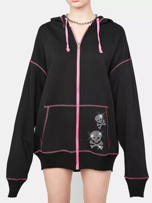 Black zip-up hoodie with pink contrast stitching and rhinestone skull graphics on the pocket.