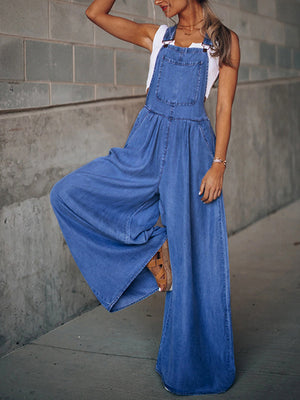 Denim overalls palazzo jumpsuit in medium wash with wide legs and a bib pocket.