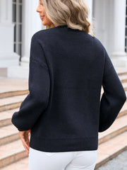 Black acrylic knit sweater with long sleeves and crew neck, ribbed cuffs and hem.
