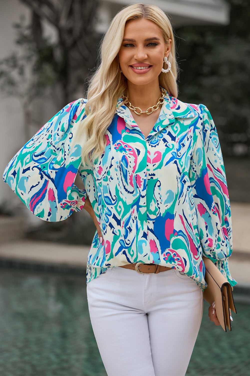 Women's abstract print blouse with gathered cuffs in blue and pink.