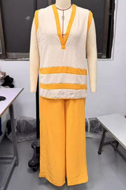 Women's yellow polyester flowy pants and striped V-neck sleeveless top ensemble.