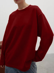Burgundy oversized crewneck sweatshirt with voluminous sleeves and crew neckline.