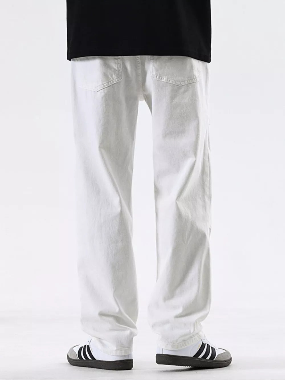 Men's white cotton jeans with a relaxed fit and pocketed design.