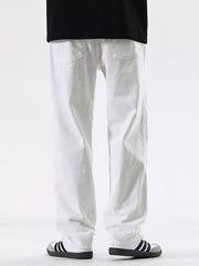 Men's white cotton jeans with a relaxed fit and pocketed design.
