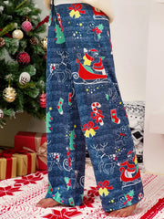 Festive print wide-leg lounge trousers in blue with Santa, reindeer, and Christmas tree patterns.