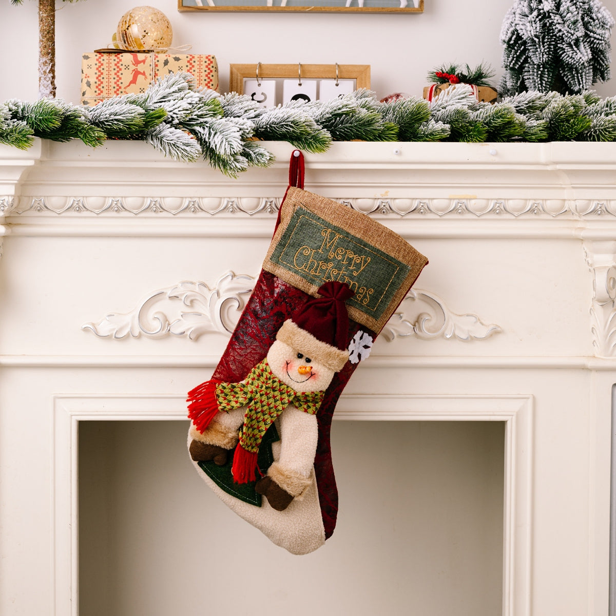 Embroidered Christmas stocking with snowman, red and green scarf, and Merry Christmas text.