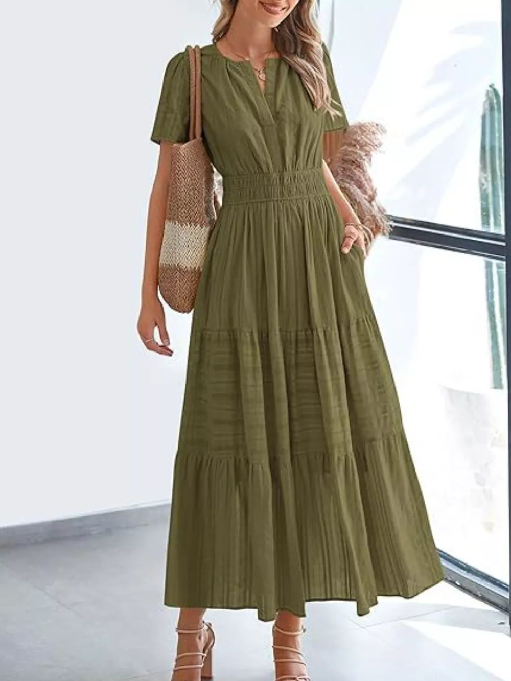 Moss green ruched V-neck tiered midi dress with smocked waist and short sleeves.