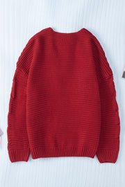 Burgundy cable knit acrylic cardigan with open front and cocoon silhouette.