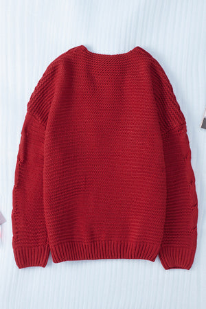 Burgundy cable knit acrylic cardigan with open front and cocoon silhouette.