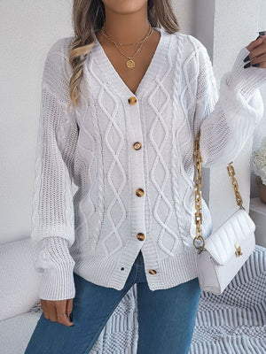 White cable knit cardigan with balloon sleeves and button front.