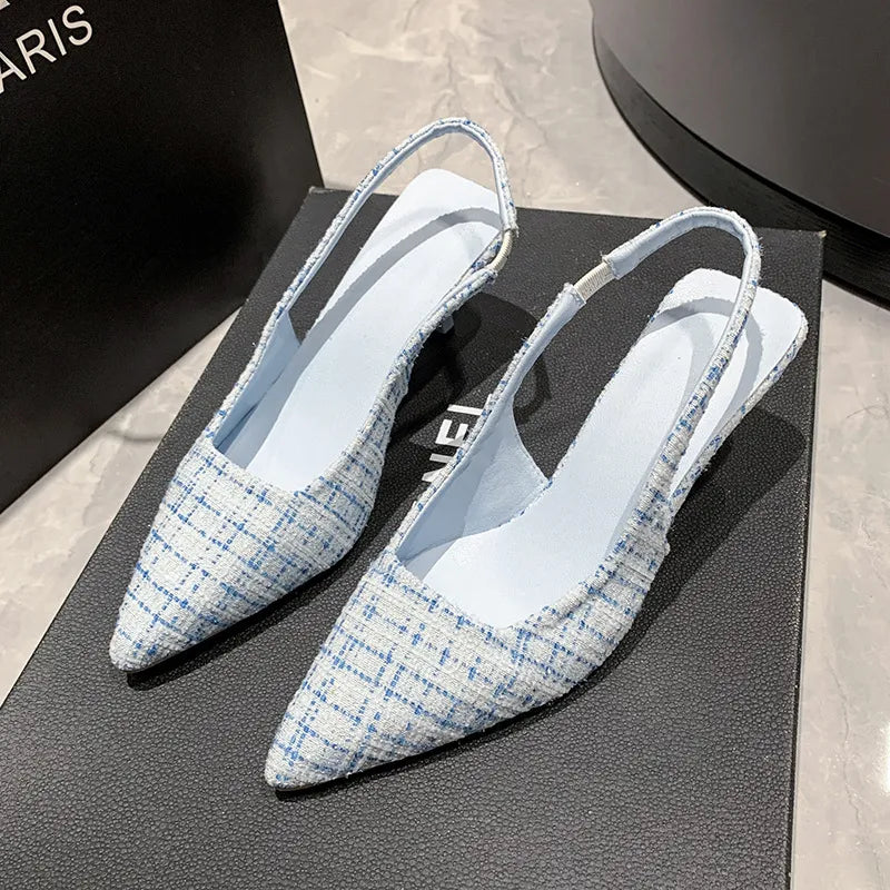 Pastel blue tweed slingback kitten heels with pointed toe and elastic ankle strap.