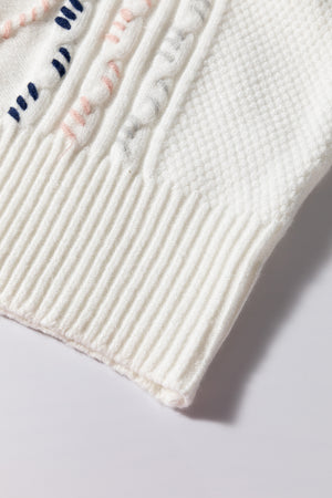 White cable knit sweater with diamond pattern and puff sleeves detail