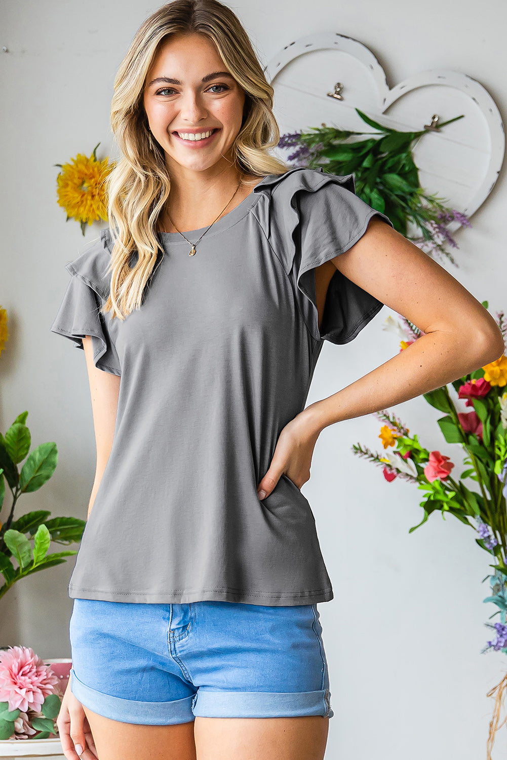 Mid gray t-shirt with ruffled short sleeves and a scoop neckline.