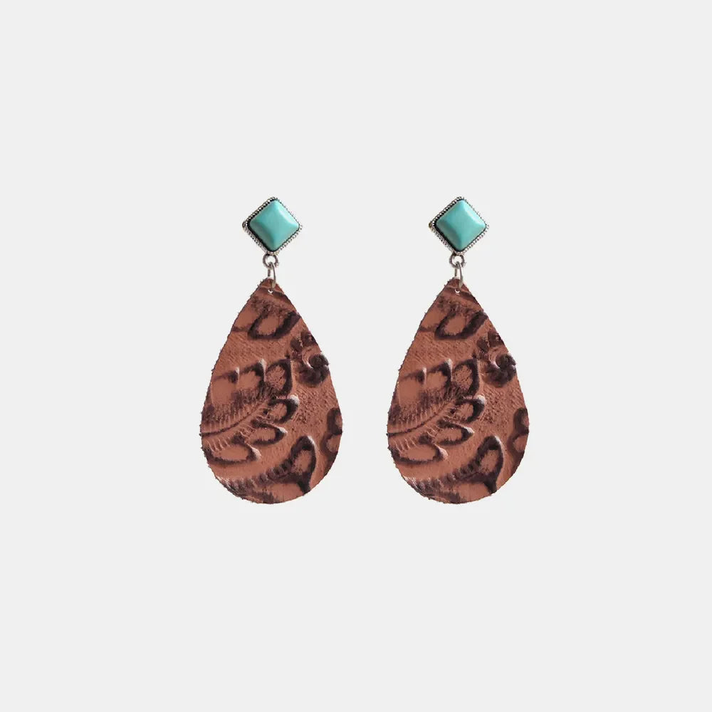 Textured leather teardrop earrings with turquoise accents and leopard print detail.