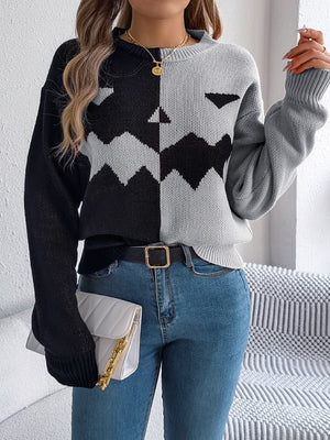 Split-face pumpkin knit sweater in black and gray with a zigzag pattern.