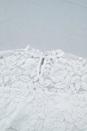 White lace blouse with ruffled neckline and tie closure detail