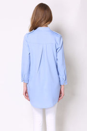 Light blue trench coat with shoulder detailing and buttoned cuffs.