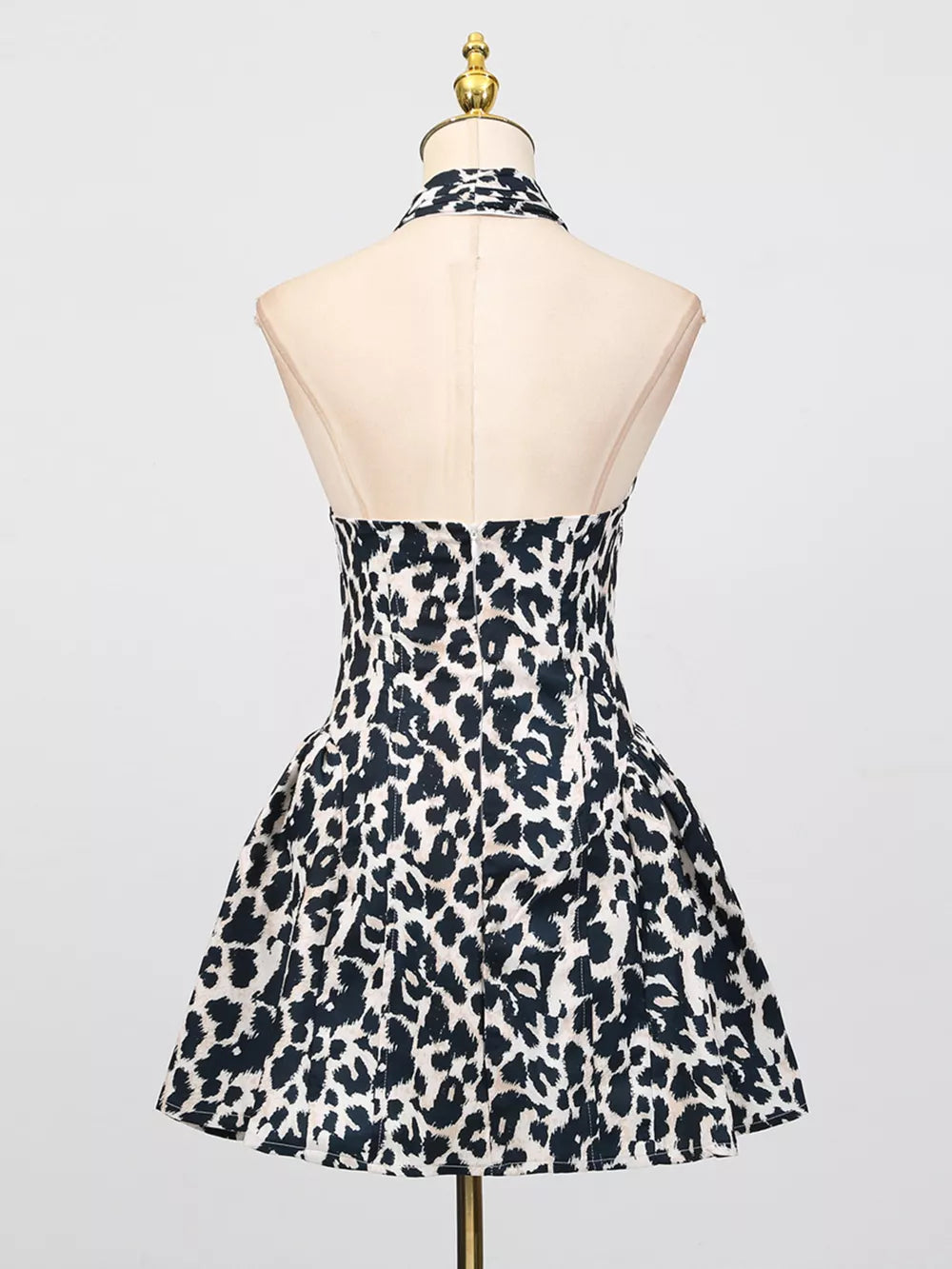 Halter neck leopard print mini dress with a flared skirt in black and white.