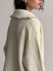 Cream ribbed knit zipper cardigan with a wide collar and silver zipper detail.