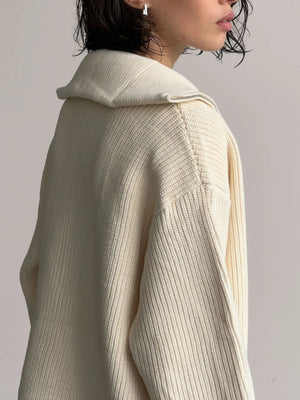 Cream ribbed knit zipper cardigan with a wide collar and silver zipper detail.