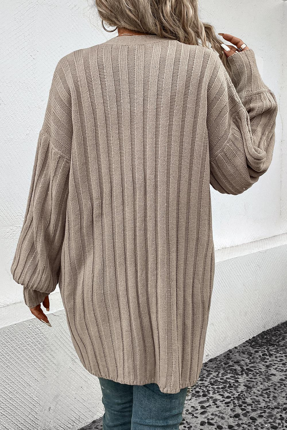 Khaki ribbed acrylic longline cardigan with balloon sleeves.