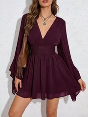 Burgundy a-line mini dress with plunging V-neck, bishop sleeves, and smocked waist.