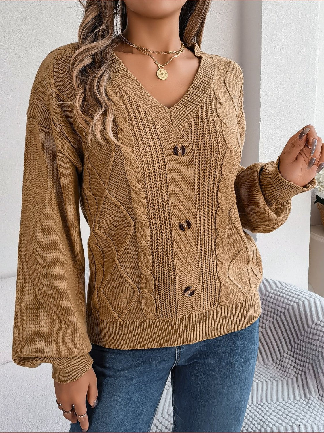 Khaki cable knit button-front cardigan with v-neck and balloon sleeves.
