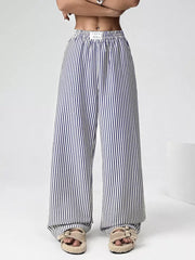 Navy striped high-waisted wide-leg pants with drawstring detail.