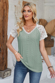 Sage eyelet raglan blouse with white lace short sleeves and V-neck.