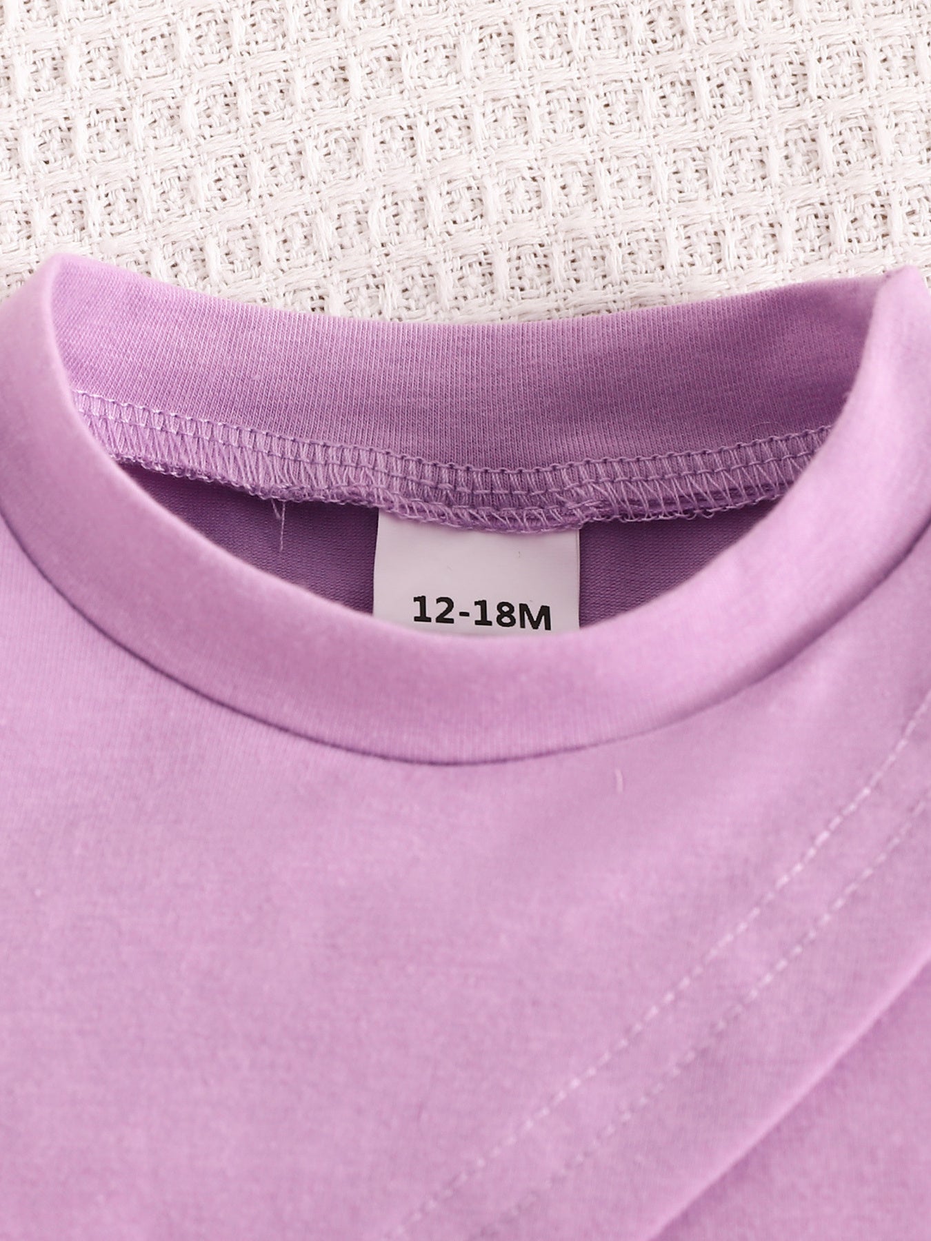 Violet toddler crop top with a crew neck and size tag 12-18M.
