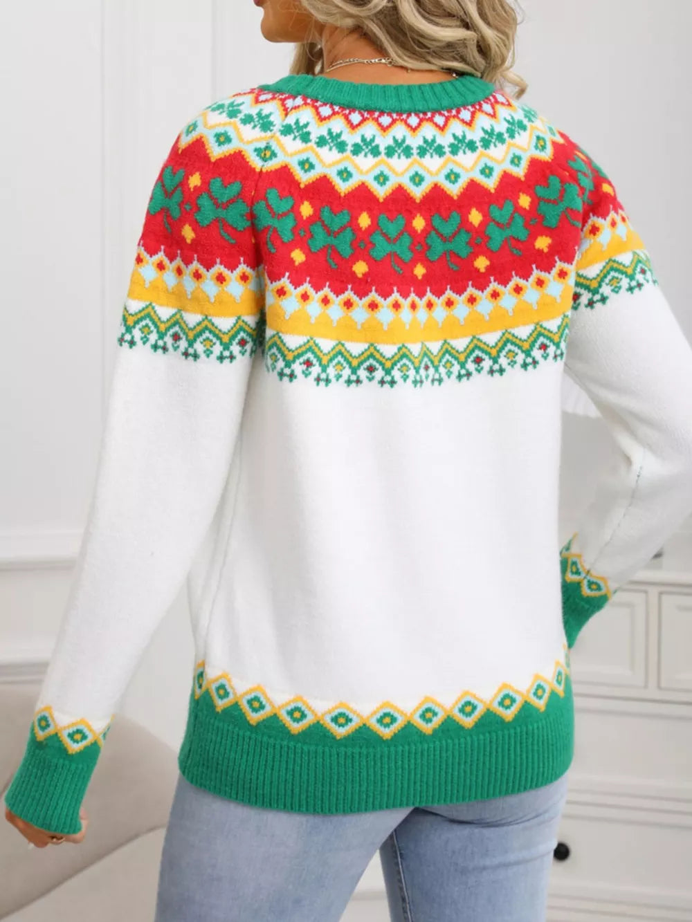 White knit sweater with charming clover and fair isle pattern, green cuffs and hem