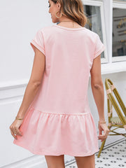 Cap sleeve drop waist t-shirt dress in blush pink cotton with a ruffled hem.