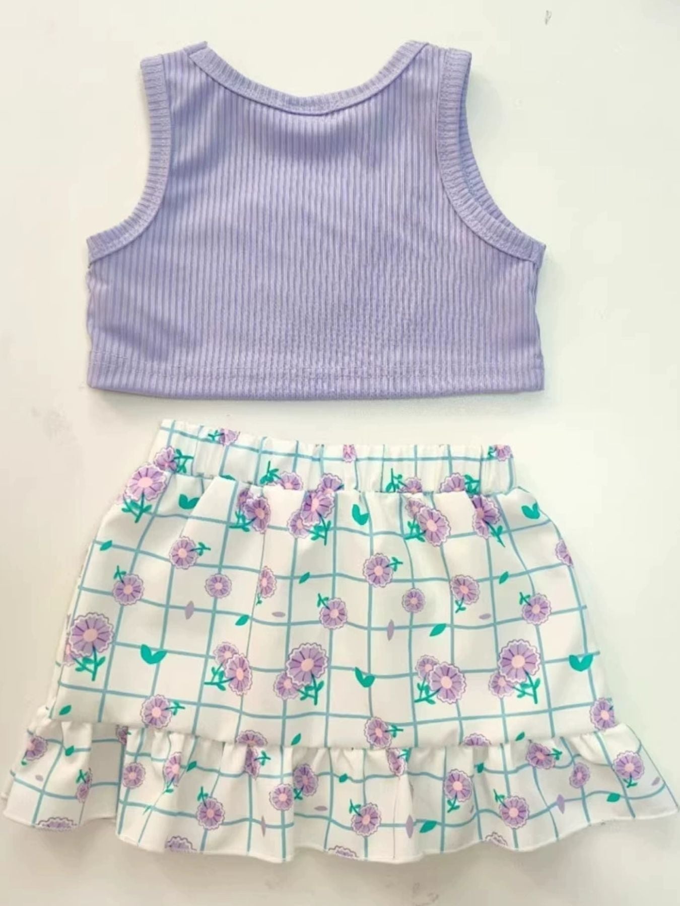 Lavender ribbed tank top and white floral grid print skirt with ruffles.
