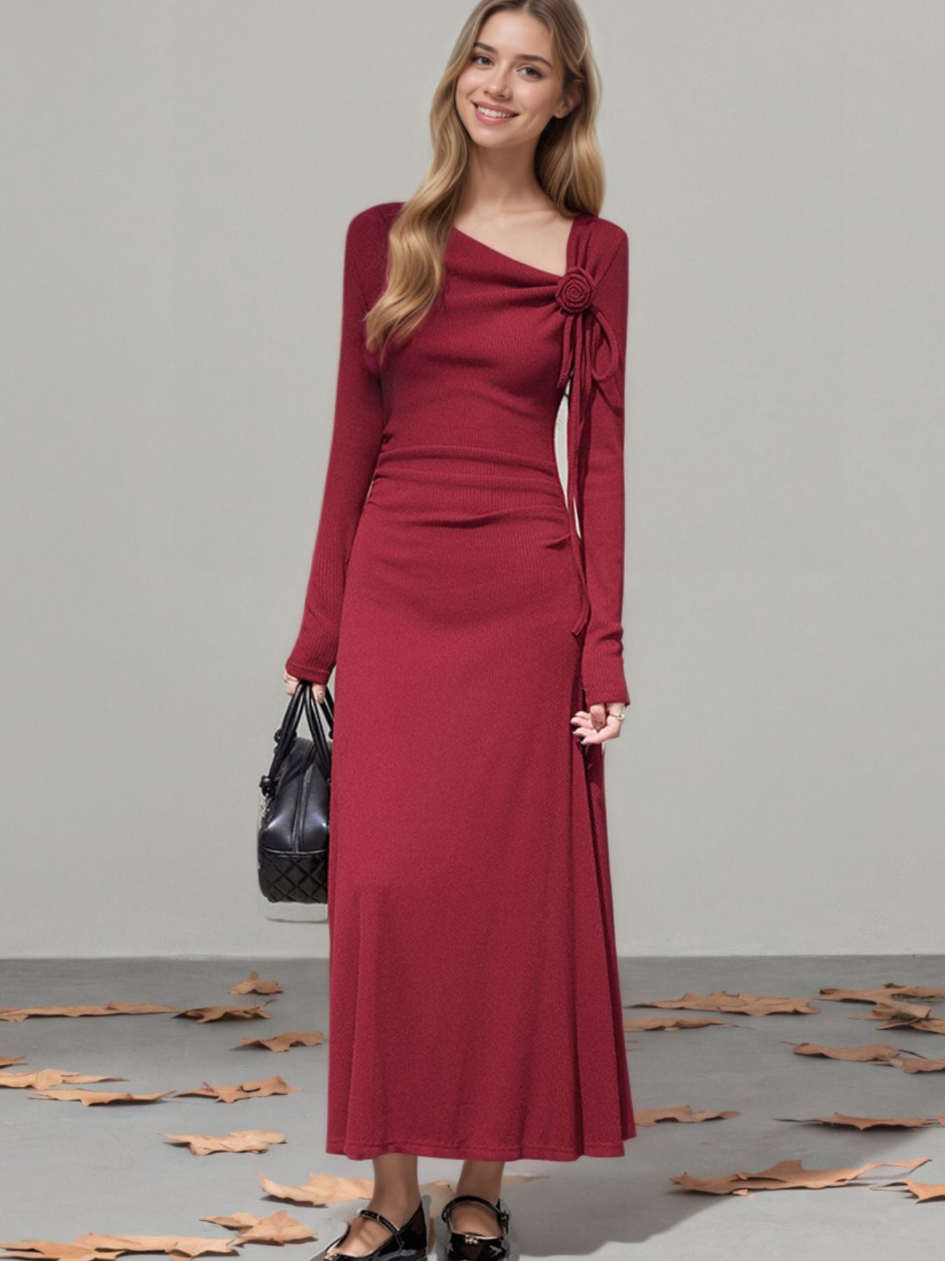 Burgundy long-sleeve maxi dress with asymmetrical neckline and ruched detail.