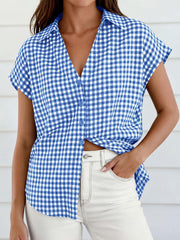 Sky blue gingham print tied button-down shirt with short sleeves and a V-neck.
