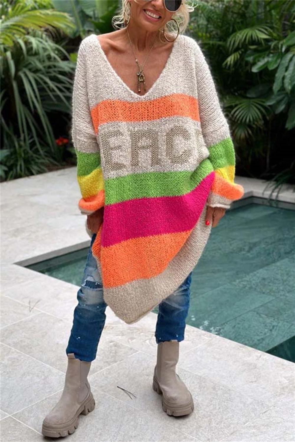 Beige knit midi sweater dress with rainbow stripes and "PEACE" lettering