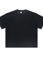 Washed black oversized t-shirt with a crewneck and raw hem details.