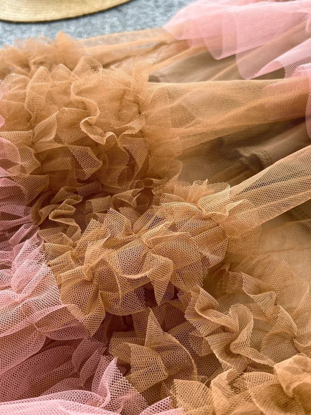 Tiered ruffle tulle skirt in brown and pink with voluminous ruffles.