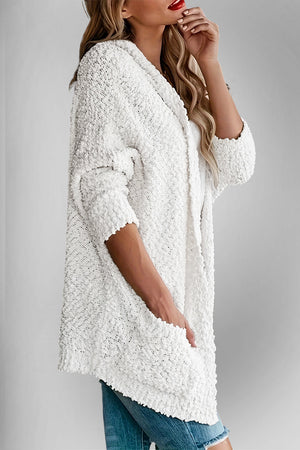 White popcorn knit open cardigan with 3/4 sleeves and pockets.