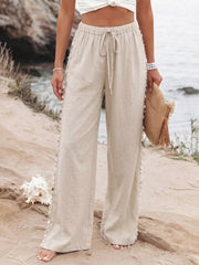 Relaxed drawstring wide-leg trousers in beige linen with shell trim and a tie waist.