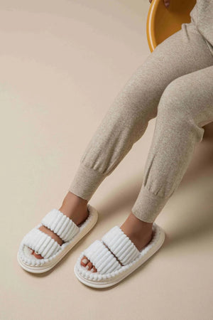 White ribbed terrycloth platform slides with double straps and a beaded sole detail.