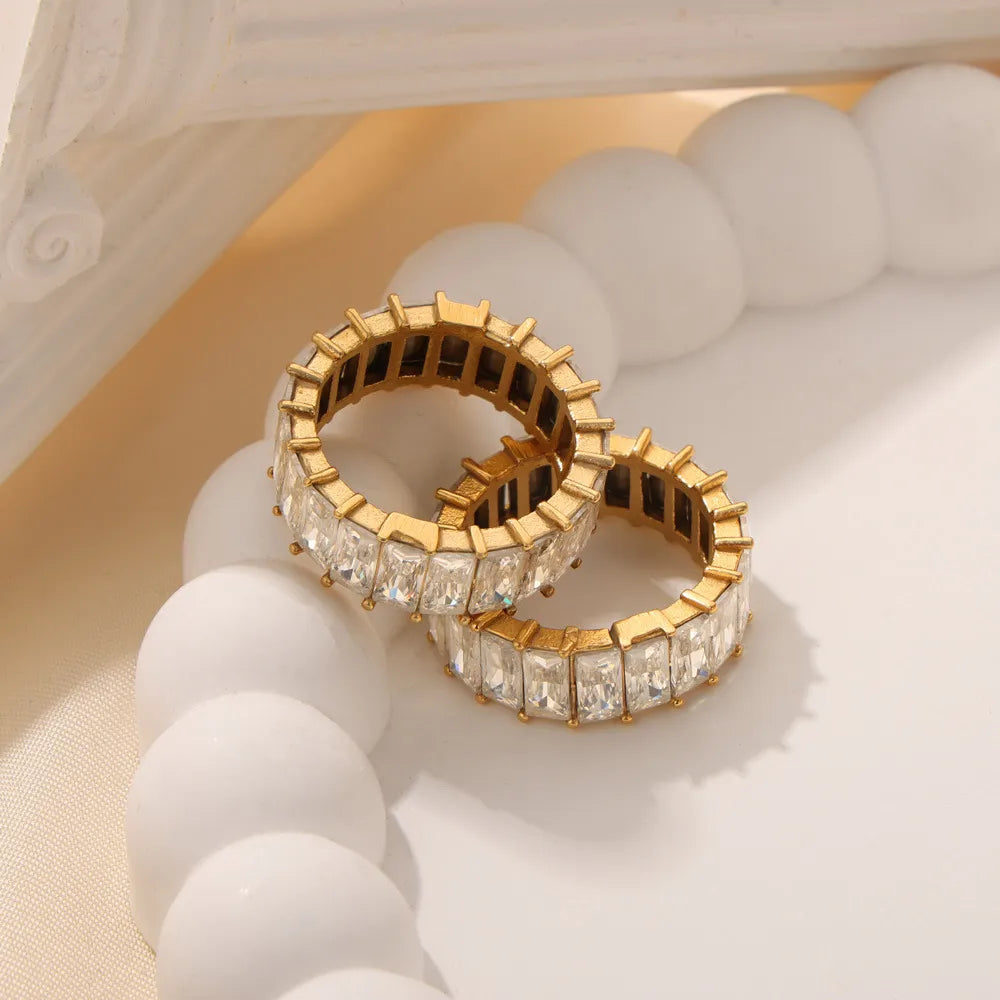 Gold baguette eternity band ring with clear square-cut stones