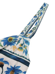 Maxi dress with blue floral print and twisted detail straps.